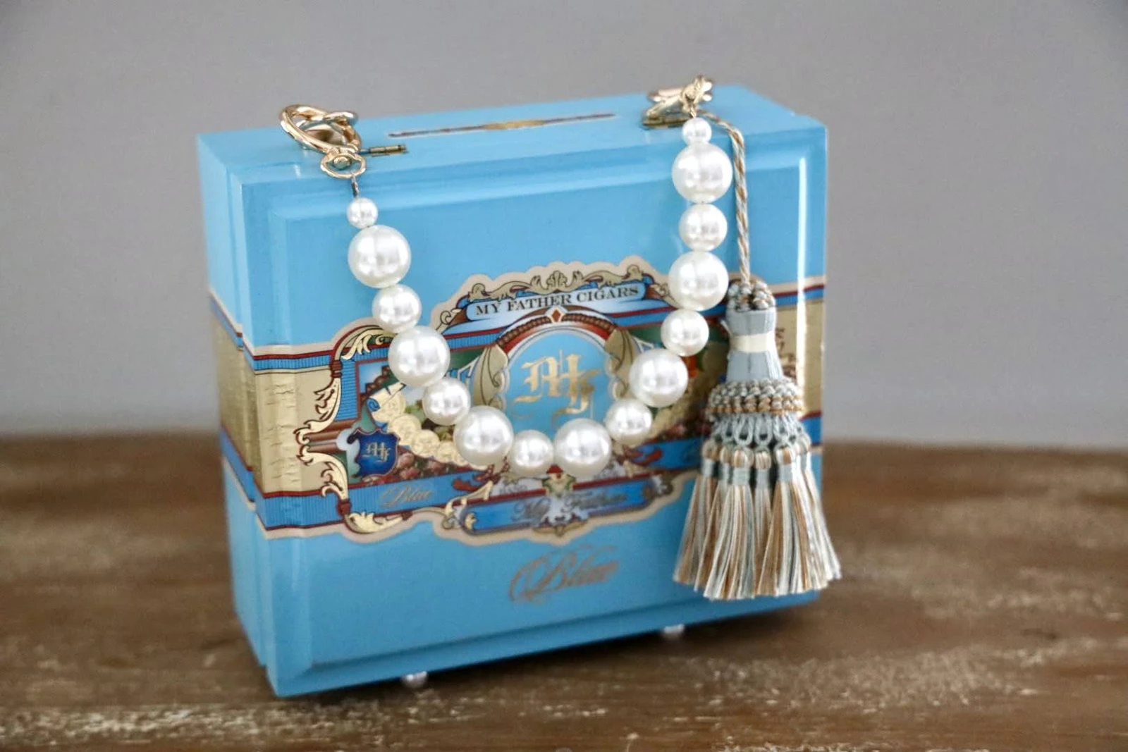 Turquoise handmade cigar-box handbag with decorative beaded handle and tassel